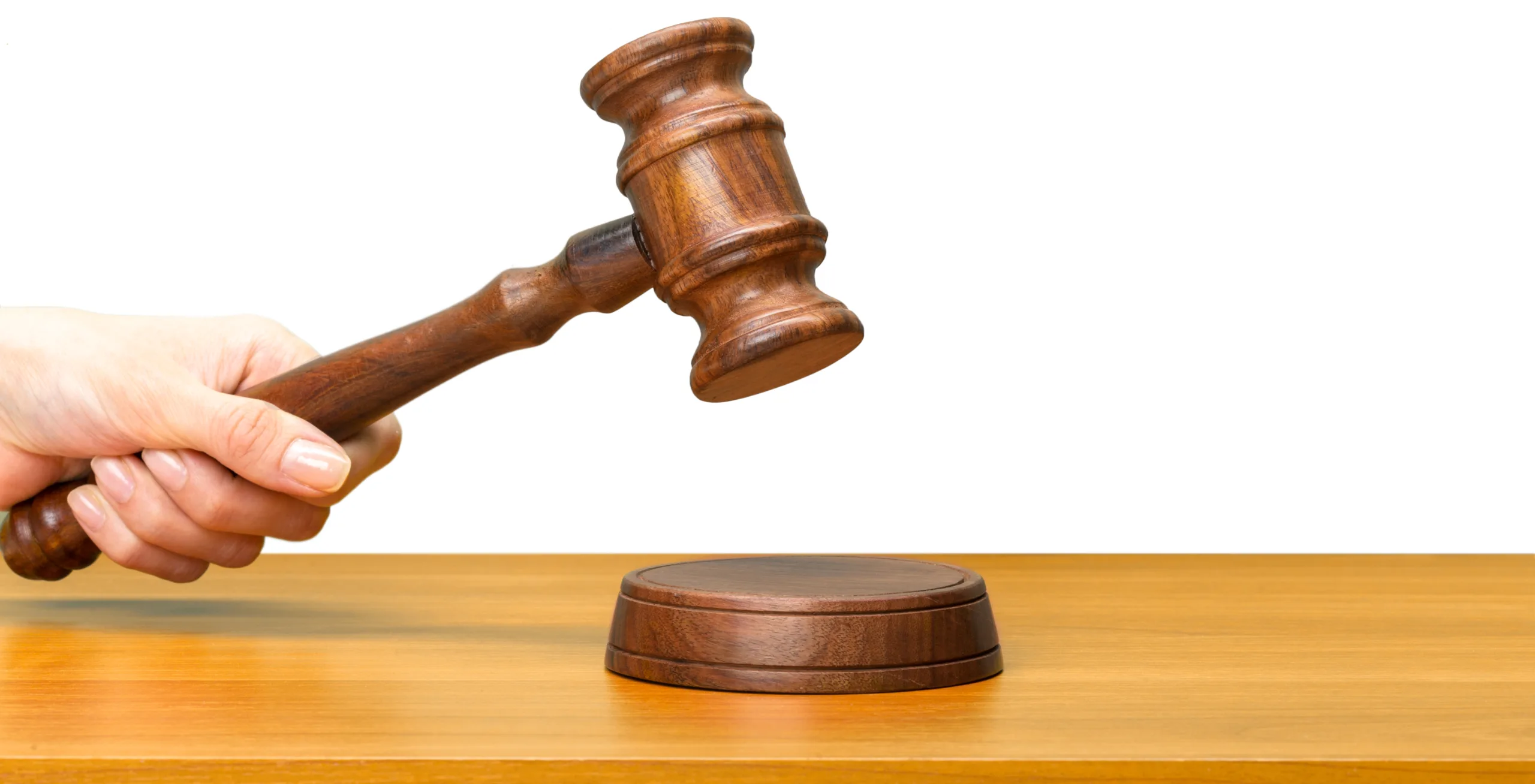 someones hand holding Wooden Law Gavel